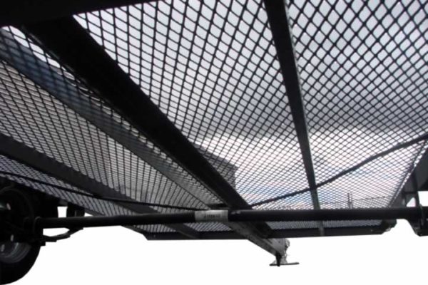 A view of the sky from underneath a metal structure.
