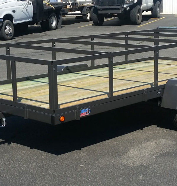 A trailer with a large metal frame on it's side.
