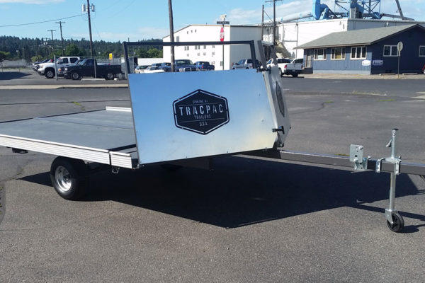 A trailer with the back of it's side open.