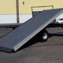 A flat bed trailer with a ramp on the back.