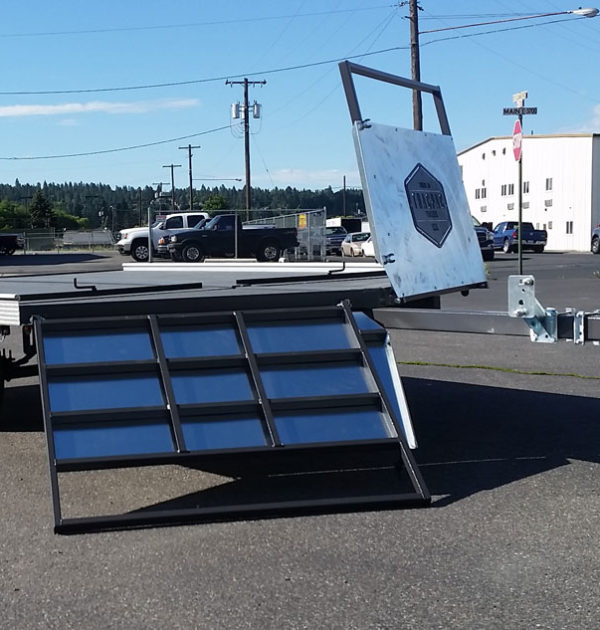 A truck with a large solar panel on the back of it.