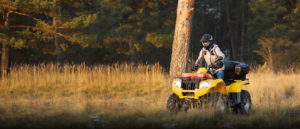 A man riding on the back of an atv.