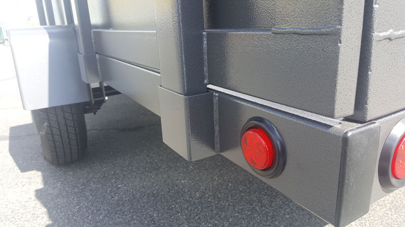 A red button is on the side of a trailer.