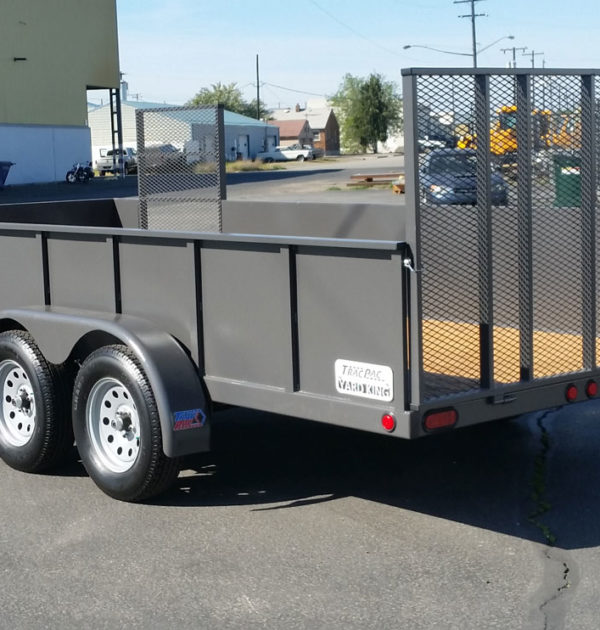 A trailer with a large metal cage on the back.
