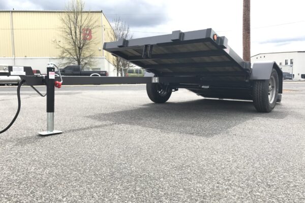 A trailer that has been placed in the middle of a parking lot.
